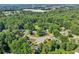 Panoramic aerial view showcases the property in a quiet neighborhood, surrounded by mature trees and manicured lawns at 6841 Fairway Ridge Dr, Douglasville, GA 30134