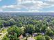 Scenic aerial view of the neighborhood showcasing lush trees, manicured lawns, and distant city skyline on the horizon at 6841 Fairway Ridge Dr, Douglasville, GA 30134
