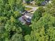 Aerial shot showing the home's deck and patio areas, surrounded by lush trees and greenery at 6841 Fairway Ridge Dr, Douglasville, GA 30134