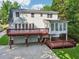 Spacious two-story home featuring a large deck, sunroom, and a convenient garage beneath at 6841 Fairway Ridge Dr, Douglasville, GA 30134