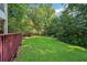 Expansive backyard featuring lush green grass perfect for recreation, and a charming deck for outdoor gatherings at 6841 Fairway Ridge Dr, Douglasville, GA 30134