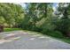 Backyard features a large patio, well-manicured lawn, mature trees, and lush landscaping, creating a private outdoor retreat at 6841 Fairway Ridge Dr, Douglasville, GA 30134