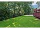 Lush backyard with mature trees surrounding the property at 6841 Fairway Ridge Dr, Douglasville, GA 30134