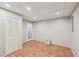 Finished basement space featuring wood-look flooring, closet, and exterior door at 6841 Fairway Ridge Dr, Douglasville, GA 30134