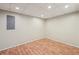 Finished basement with wood-look flooring and bright recessed lighting at 6841 Fairway Ridge Dr, Douglasville, GA 30134