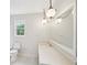 Bathroom with decorative hanging light, white tile, and quartz counter at 6841 Fairway Ridge Dr, Douglasville, GA 30134