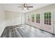 This bedroom features luxury vinyl floors and french doors to a deck at 6841 Fairway Ridge Dr, Douglasville, GA 30134