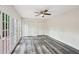 This bedroom features luxury vinyl floors, a ceiling fan, and french doors to the deck at 6841 Fairway Ridge Dr, Douglasville, GA 30134
