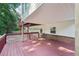 Covered deck with view of the garage and driveway, and backyard at 6841 Fairway Ridge Dr, Douglasville, GA 30134