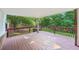 Covered deck overlooking lush backyard with a brick support structure at 6841 Fairway Ridge Dr, Douglasville, GA 30134