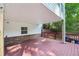 Covered deck overlooking the manicured backyard with brick accents at 6841 Fairway Ridge Dr, Douglasville, GA 30134