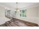 This dining room features a bay window, chair railing, and stylish chandelier at 6841 Fairway Ridge Dr, Douglasville, GA 30134