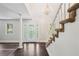 Bright foyer featuring hardwood floors, a chandelier, staircase, and a decorative glass front door at 6841 Fairway Ridge Dr, Douglasville, GA 30134