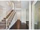 Elegant foyer featuring a grand staircase, a chandelier, and hardwood flooring, bathed in natural light at 6841 Fairway Ridge Dr, Douglasville, GA 30134