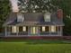 Charming home boasts a brick facade, dormer windows, and a welcoming front porch at 6841 Fairway Ridge Dr, Douglasville, GA 30134