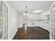 Open kitchen with white cabinetry, modern countertops, and dark hardwood flooring at 6841 Fairway Ridge Dr, Douglasville, GA 30134