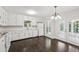 Well-lit kitchen with all-white cabinets, stainless steel hardware, and adjacent french doors at 6841 Fairway Ridge Dr, Douglasville, GA 30134