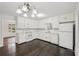 Bright kitchen featuring all-white cabinets, matching appliances, and hardwood floors at 6841 Fairway Ridge Dr, Douglasville, GA 30134