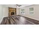 Inviting living room featuring a stone fireplace with built-in shelving, hardwood floors, and natural lighting at 6841 Fairway Ridge Dr, Douglasville, GA 30134