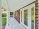 Welcoming covered porch with white columns, brick accents, and a view of the landscaped yard at 6841 Fairway Ridge Dr, Douglasville, GA 30134