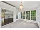 Bright sunroom with kitchen view, natural lighting, and walls of windows overlooking yard at 6841 Fairway Ridge Dr, Douglasville, GA 30134