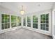 Sunroom with multiple windows bringing natural light and outdoor scenery inside at 6841 Fairway Ridge Dr, Douglasville, GA 30134
