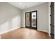 Bedroom features hardwood floors, neutral walls and black French doors to a small patio at 2329 Mason Dr # D24, Atlanta, GA 30316