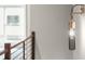 Hallway with stylish modern lighting fixture and a sleek wood and metal guardrail at 2329 Mason Dr # D24, Atlanta, GA 30316