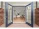 View through the French doors to the home's open floor plan and the hardwood floors at 2329 Mason Dr # D24, Atlanta, GA 30316