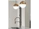 Modern island sink with faucet close-up, under pendant lights at 2329 Mason Dr # D24, Atlanta, GA 30316