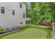 Backyard putting green alongside house, with a cozy deck and wooded surroundings at 2602 Drew Valley Ne Rd, Brookhaven, GA 30319