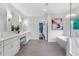 Elegant bathroom featuring double vanity, soaking tub, and modern chandelier at 2602 Drew Valley Ne Rd, Brookhaven, GA 30319