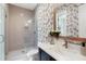Elegant bathroom with a glass shower, floral wallpaper and modern fixtures at 2602 Drew Valley Ne Rd, Brookhaven, GA 30319