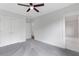 Bedroom featuring light gray walls, plush carpet, and white doors, with an ensuite bathroom in view at 2602 Drew Valley Ne Rd, Brookhaven, GA 30319