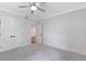 Spacious bedroom featuring plush carpeting, ceiling fan, and an ensuite bathroom entrance at 2602 Drew Valley Ne Rd, Brookhaven, GA 30319