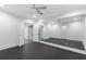 Bedroom featuring a ceiling fan, a mirrored wall, and an open doorway at 2602 Drew Valley Ne Rd, Brookhaven, GA 30319
