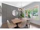Beautiful dining room showcases a stylish light fixture, decorative wall and large windows at 2602 Drew Valley Ne Rd, Brookhaven, GA 30319