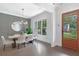 Bright dining room featuring hardwood floors, modern chandelier and natural light at 2602 Drew Valley Ne Rd, Brookhaven, GA 30319