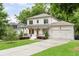 Attractive two-story home with a covered front porch, green lawn, and an attached two-car garage at 2602 Drew Valley Ne Rd, Brookhaven, GA 30319