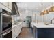 Modern kitchen with stainless steel appliances, custom cabinetry, and a large island with a prep sink at 2602 Drew Valley Ne Rd, Brookhaven, GA 30319