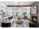 Open-concept living room with modern fireplace, hardwood floors, stylish decor, and ample natural light at 2602 Drew Valley Ne Rd, Brookhaven, GA 30319