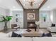 Comfortable living room with fireplace, wooden beams, stylish lighting, and a neutral color palette at 2602 Drew Valley Ne Rd, Brookhaven, GA 30319
