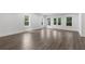 Living room with beautiful flooring, multiple windows, and glass doors to the outside at 2602 Drew Valley Ne Rd, Brookhaven, GA 30319