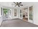 Screened-in porch with wood floors, ceiling fan, and access to the kitchen through sliding glass doors at 2602 Drew Valley Ne Rd, Brookhaven, GA 30319