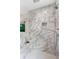 Luxurious shower with marble tile and rain shower head at 2602 Drew Valley Ne Rd, Brookhaven, GA 30319