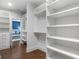 Organized walk-in closet with built-in shelves and a view of the bedroom at 2602 Drew Valley Ne Rd, Brookhaven, GA 30319