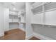 Spacious walk-in closet with custom shelving and hardwood floors at 2602 Drew Valley Ne Rd, Brookhaven, GA 30319