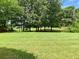 Spacious backyard with lush green lawn and mature trees at 9602 Coastal Pointe Dr, Villa Rica, GA 30180