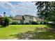 Spacious backyard with lush landscaping, mature trees, and a well-maintained lawn at 9602 Coastal Pointe Dr, Villa Rica, GA 30180