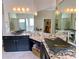 Bathroom with dual vessel sinks, granite countertops, and custom mirrors enhances the contemporary design at 9602 Coastal Pointe Dr, Villa Rica, GA 30180